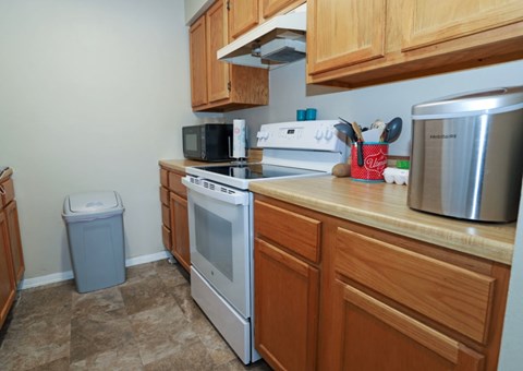 A kitchen with a stove, oven, microwave, and toaster.