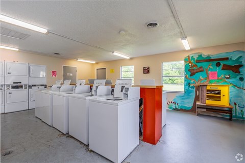 A laundry room with washers and dryers.