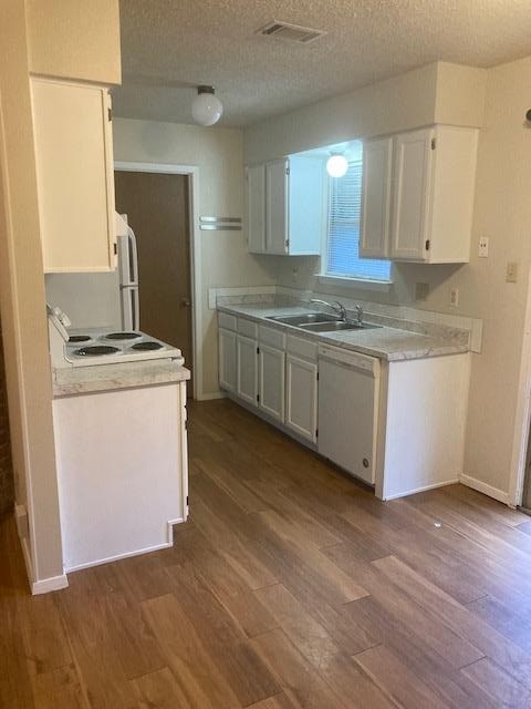 A kitchen with a white fridge and a white stove.
