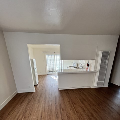 A room with wooden floors and white walls.