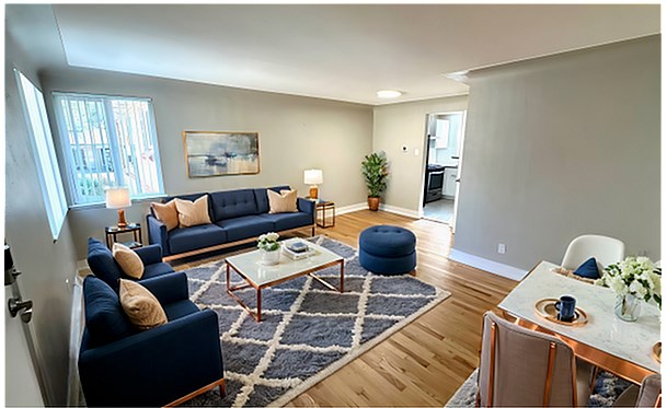 A living room with a blue couch and a coffee table.