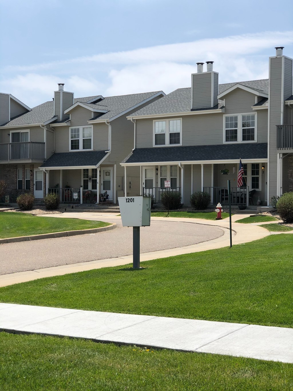 A residential building with a mailbox in front.