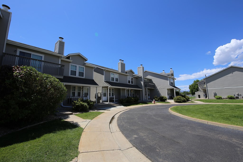 A sunny day at a residential area with houses and a clear blue sky.