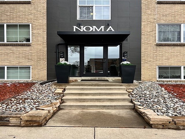 The front of a building with the word NOMA above the entrance.