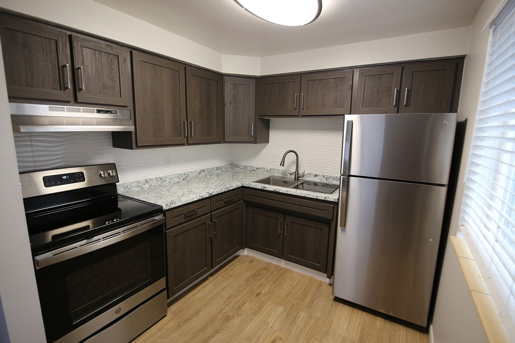 A kitchen with a dining table and chairs.