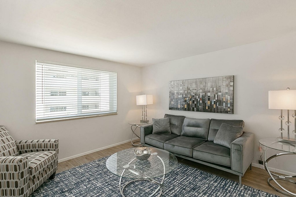 A bedroom with a bed, carpet, and a ceiling fan.