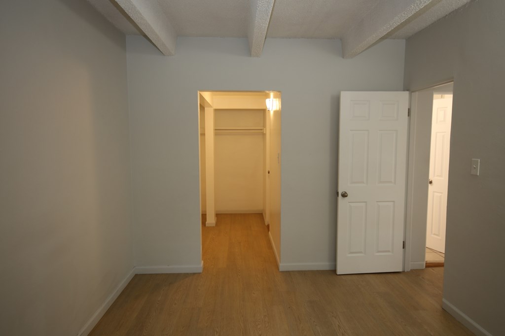 A room with a white door and a light on.