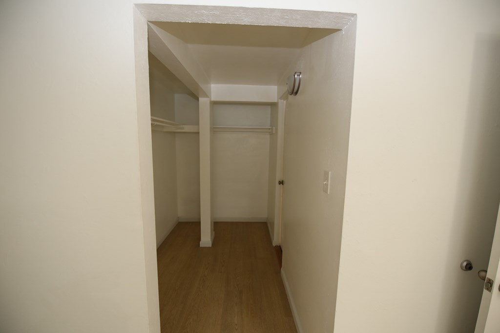 A white hallway with a door on the right.
