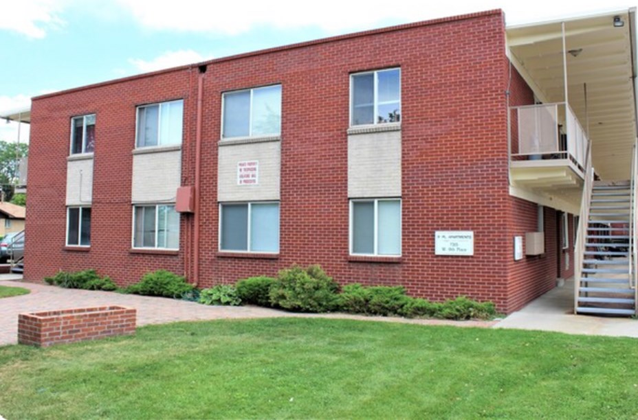 A red brick building with a white sign on the front.