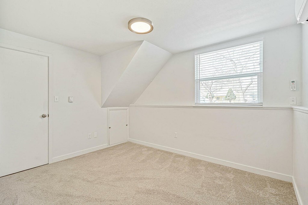 A room with a window and a door.