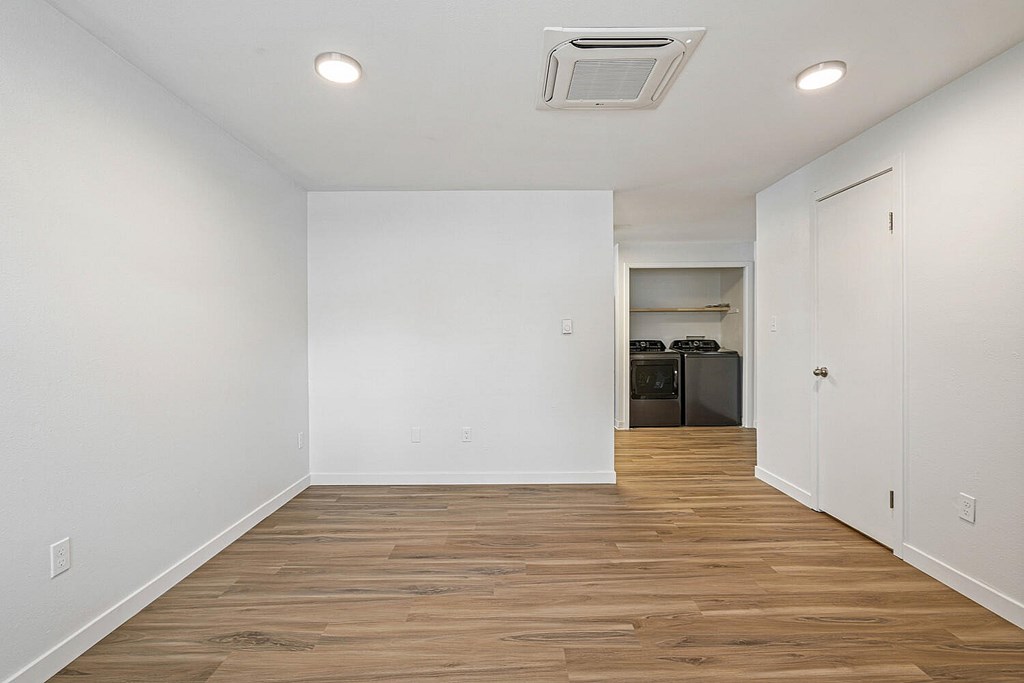 A room with wooden floors and white walls.