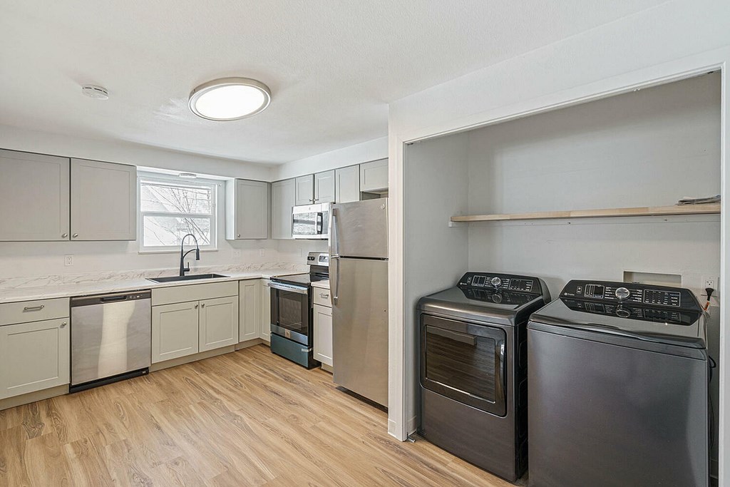 A kitchen with a black oven and stove top.