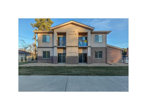 A two-story house with a balcony on the second floor.