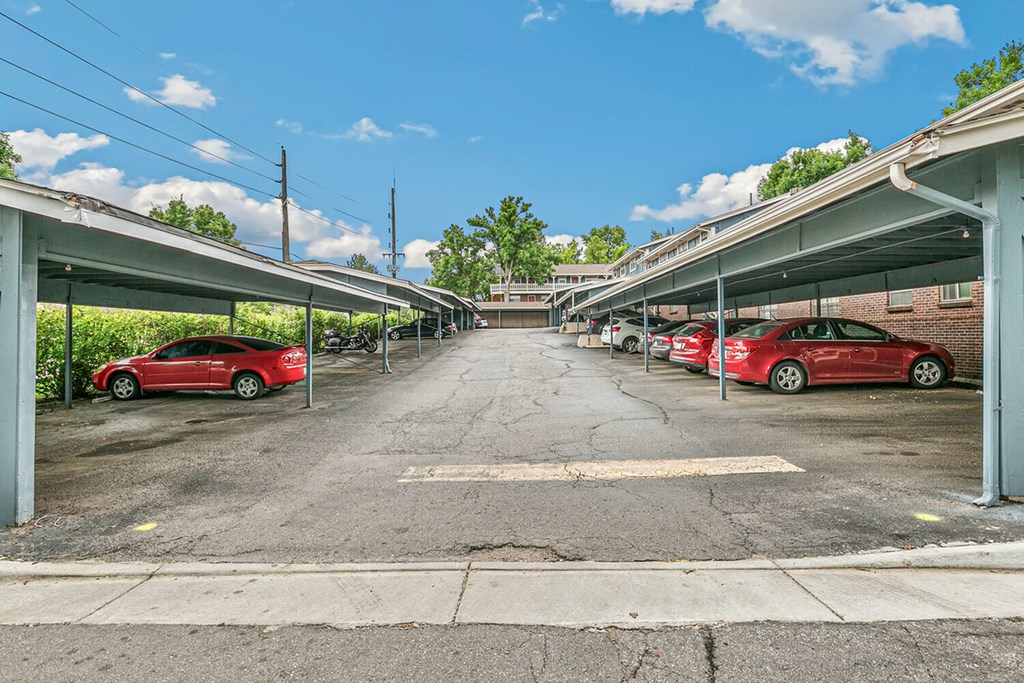 A parking lot with red cars and a white car in the middle.
