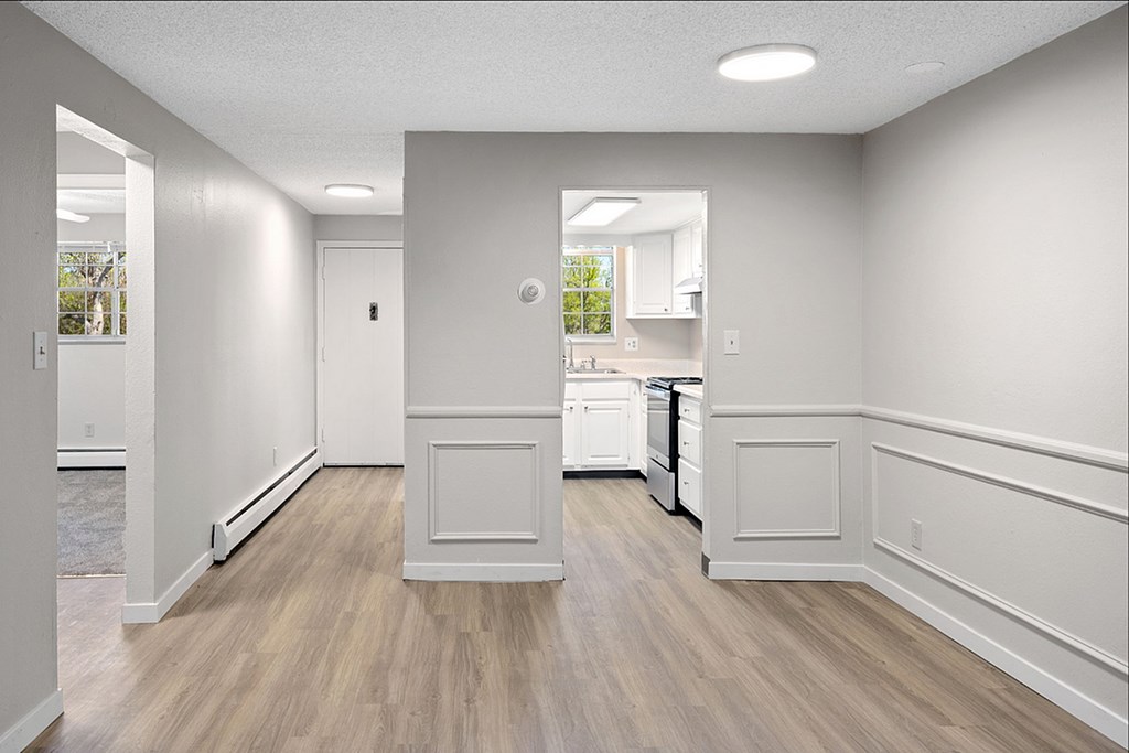 A kitchen with white cabinets and a white dishwasher.
