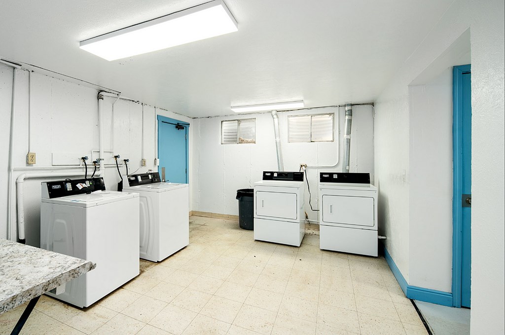 A laundry room with washers and dryers.
