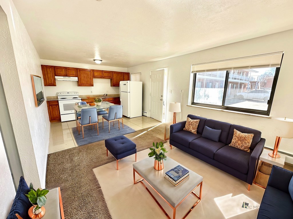 A living room with a blue couch and a coffee table.