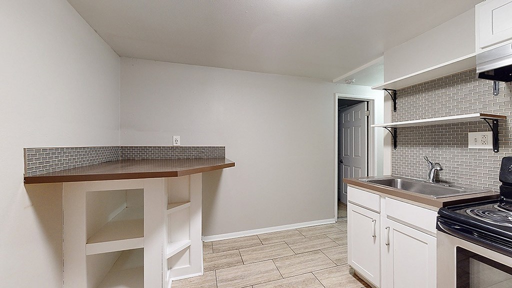 A kitchen with a counter and a sink.