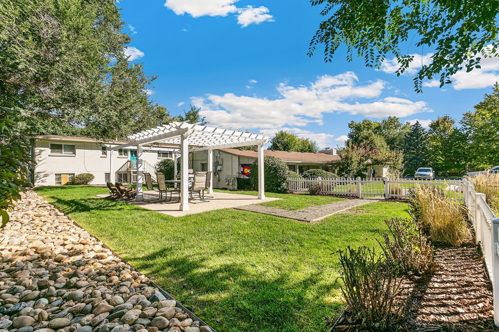 A kitchen with black appliances and wooden floors.
