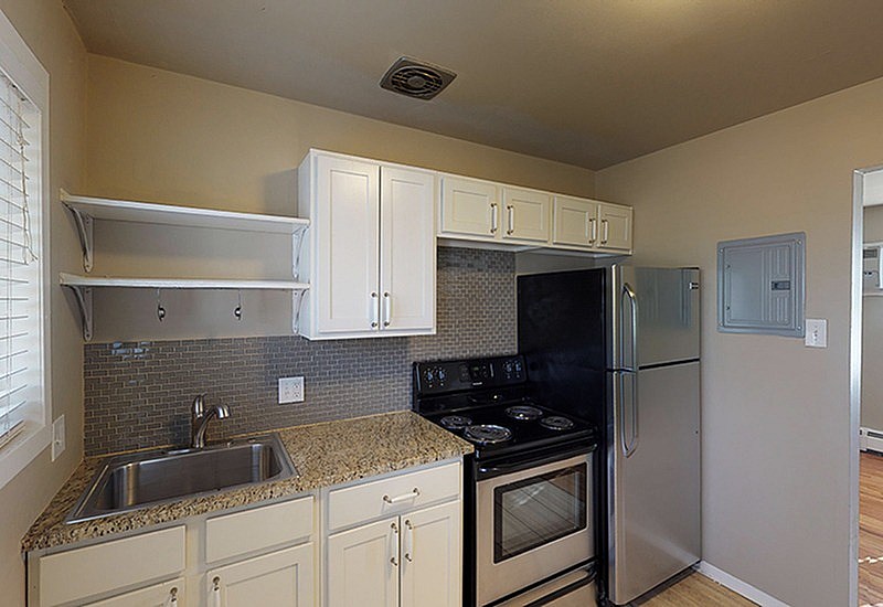 A kitchen with a stove, oven, and refrigerator.