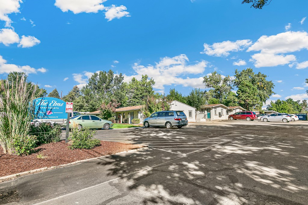 A room with a white door and a grey wall.