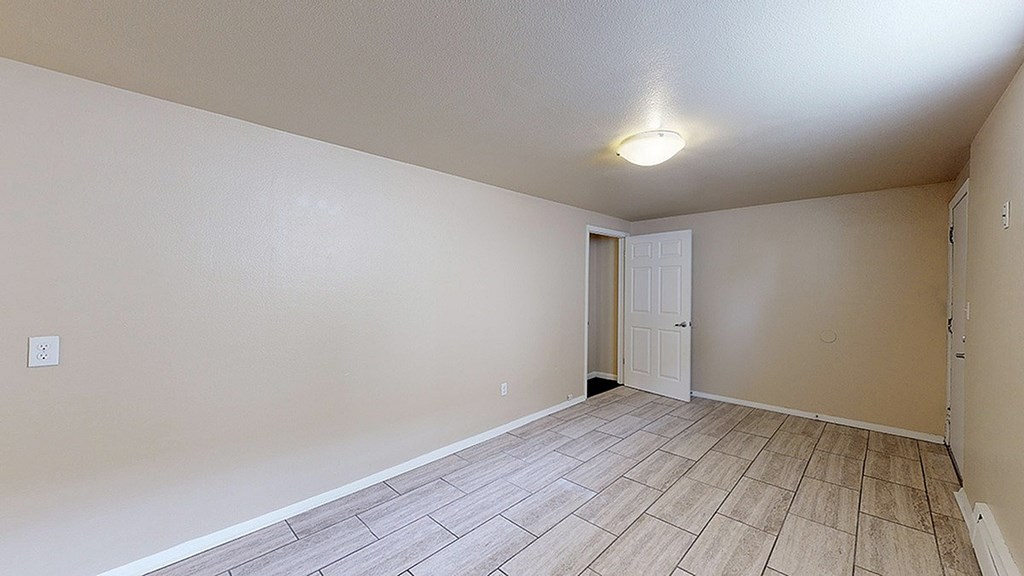 A room with a door and a light on the ceiling.