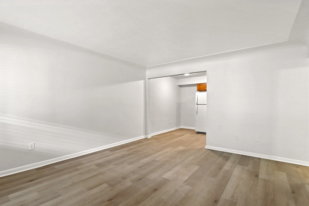 A room with wooden floors and white walls.