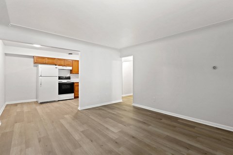 A kitchen with white cabinets and a wooden countertop is visible.