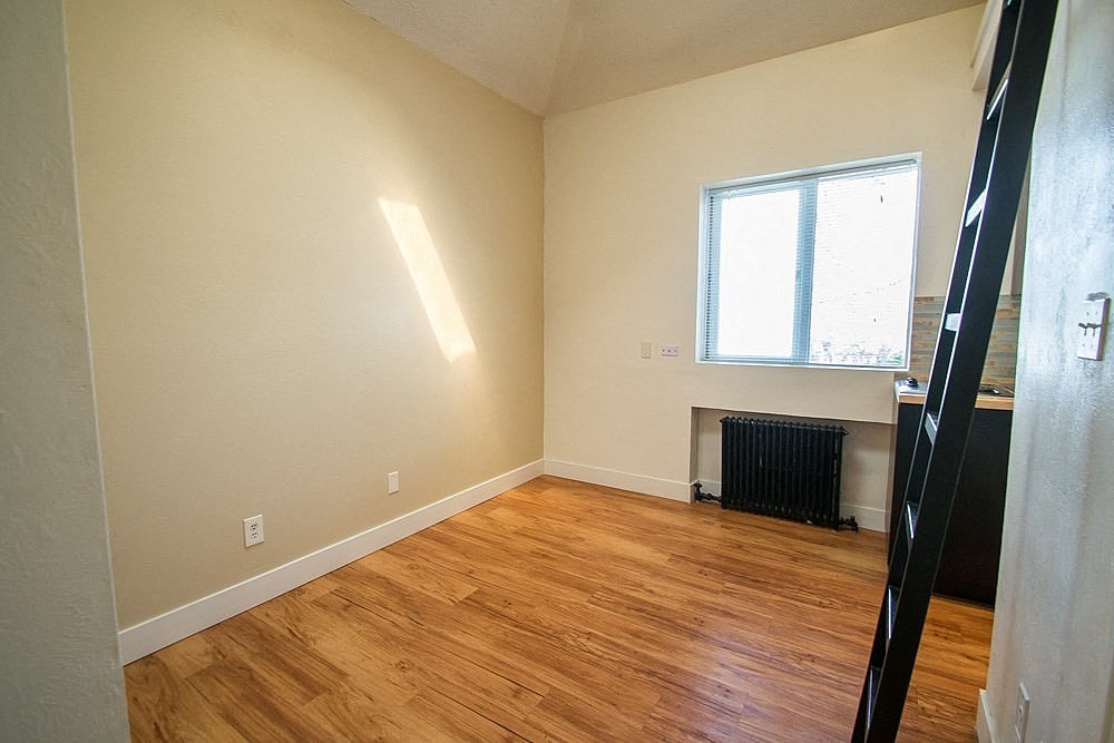 A room with wooden floors and a window.