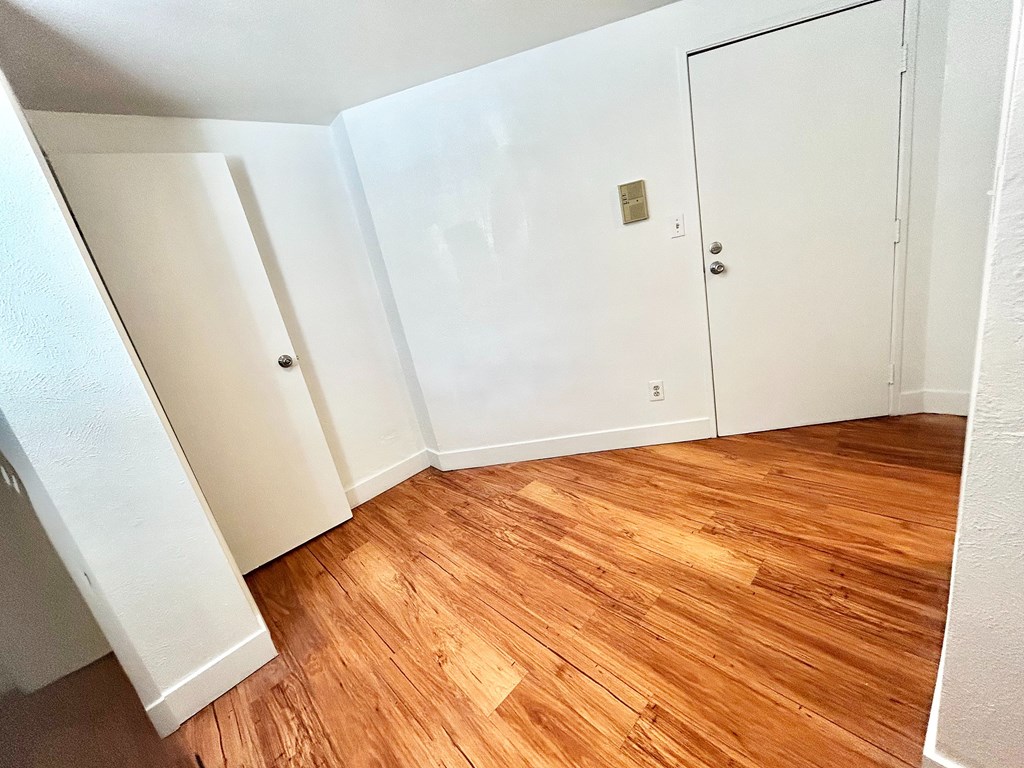 A room with wooden floors and white walls.