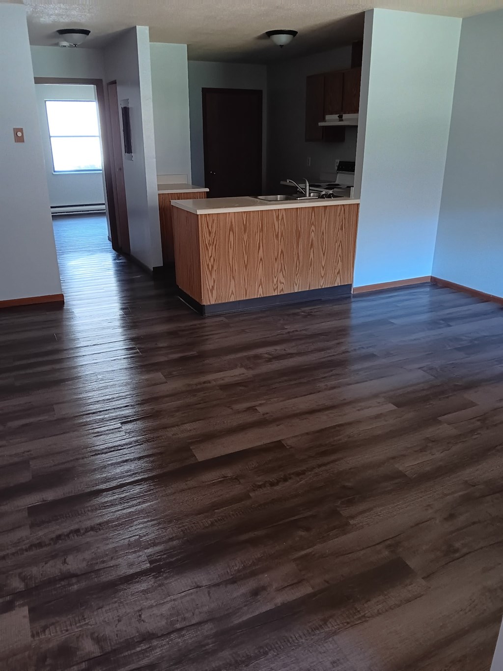 A room with a wooden floor and a counter.