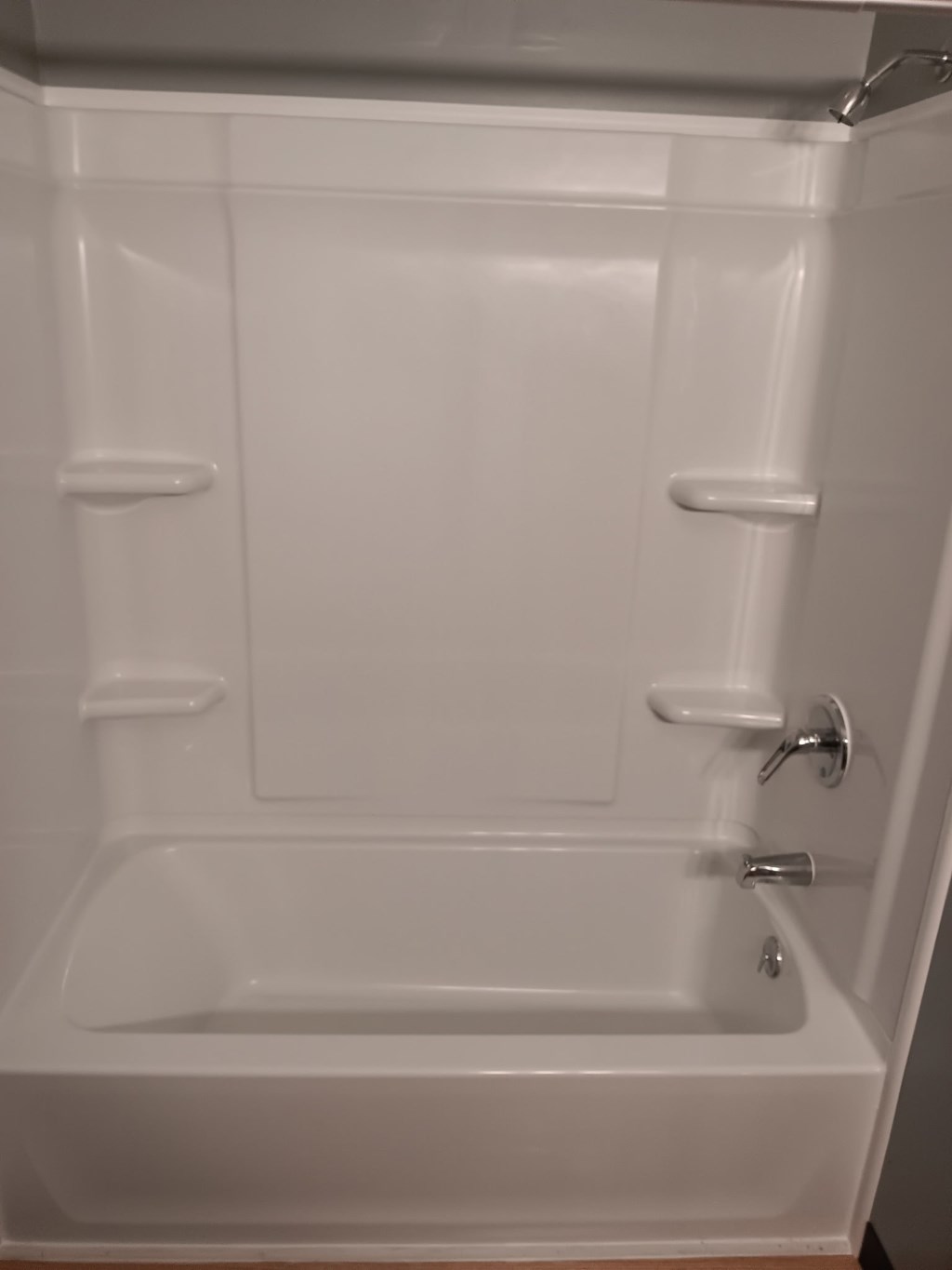 A white bathtub with a silver faucet and handles.