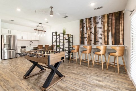 A modern kitchen with a wooden table and chairs.