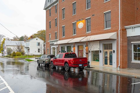 Two trucks are parked in front of a building.