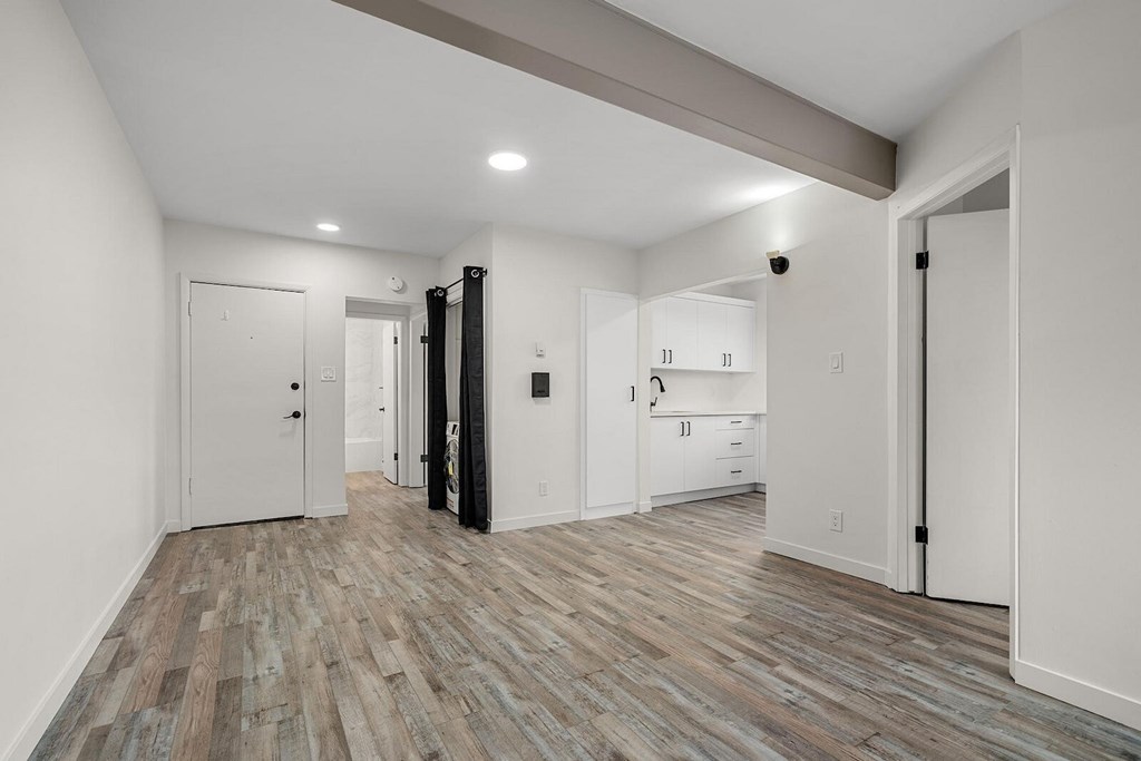 A room with a white door and a black door.