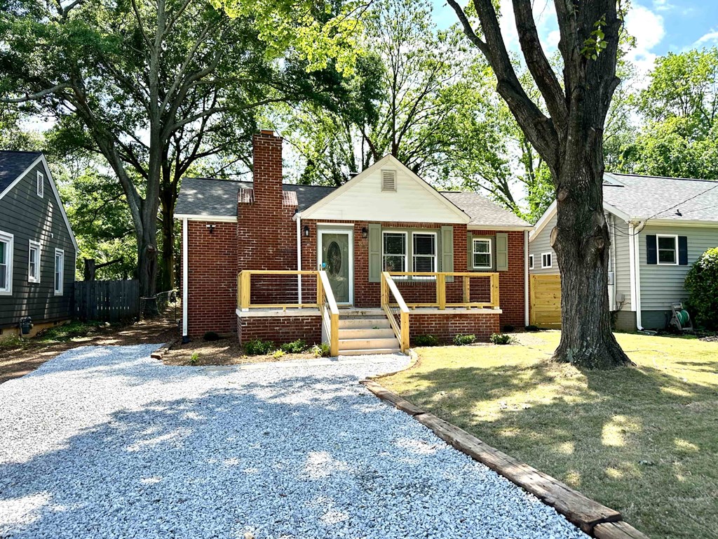 A small house with a brick chimney and a porch.