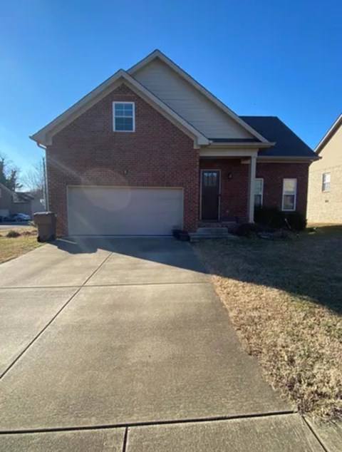 A red brick house with a white garage door.