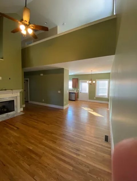 A room with a fireplace and a ceiling fan.