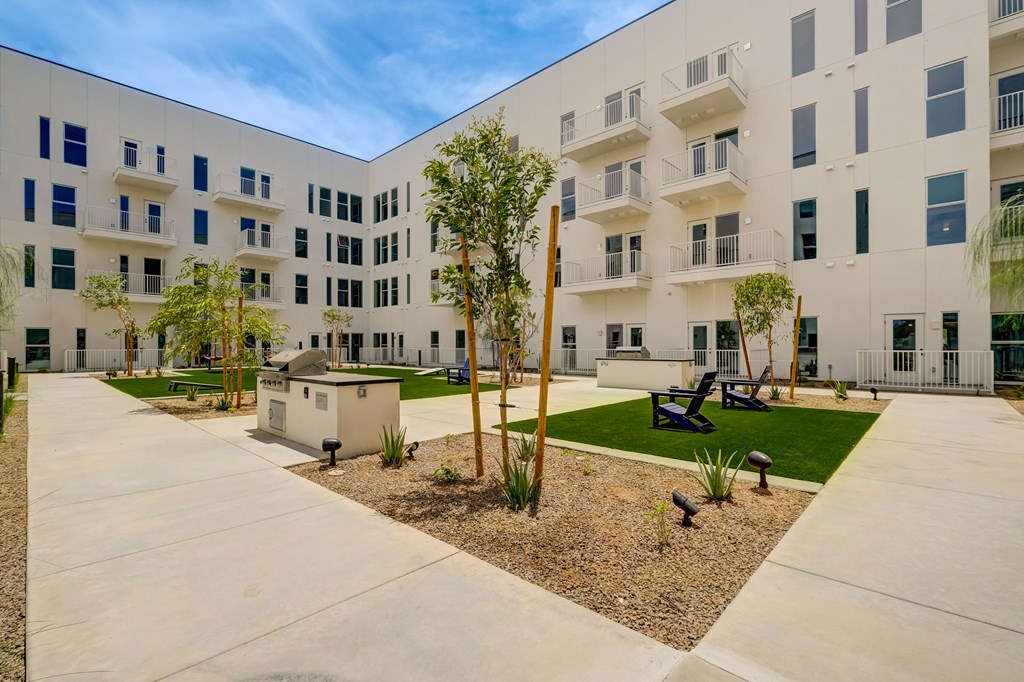 A modern building with a courtyard in front.
