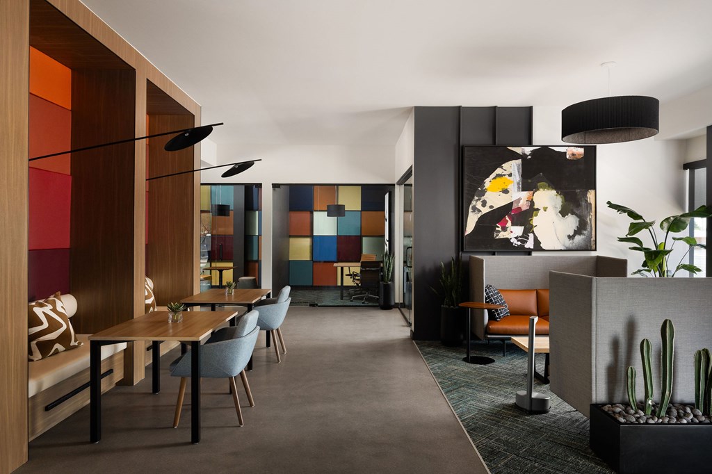 A modern dining room with a wooden table and chairs.