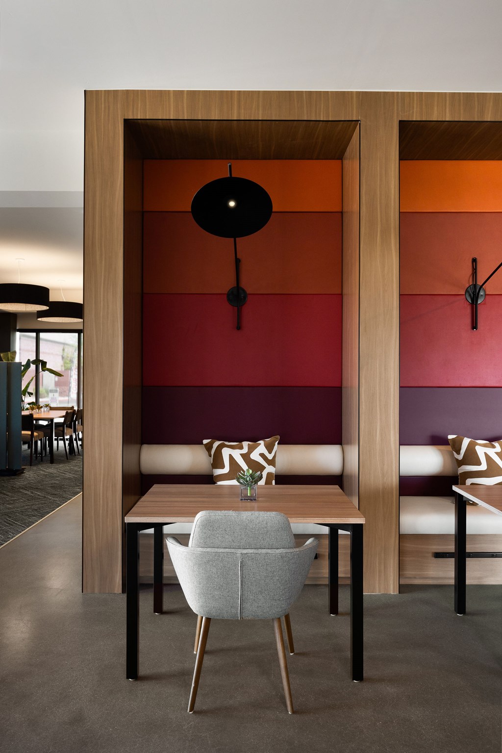 A modern dining room with a wooden table and chairs.