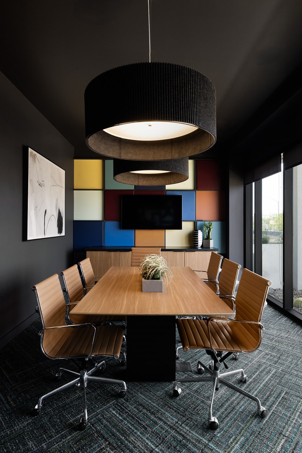A conference room with a long table and chairs.