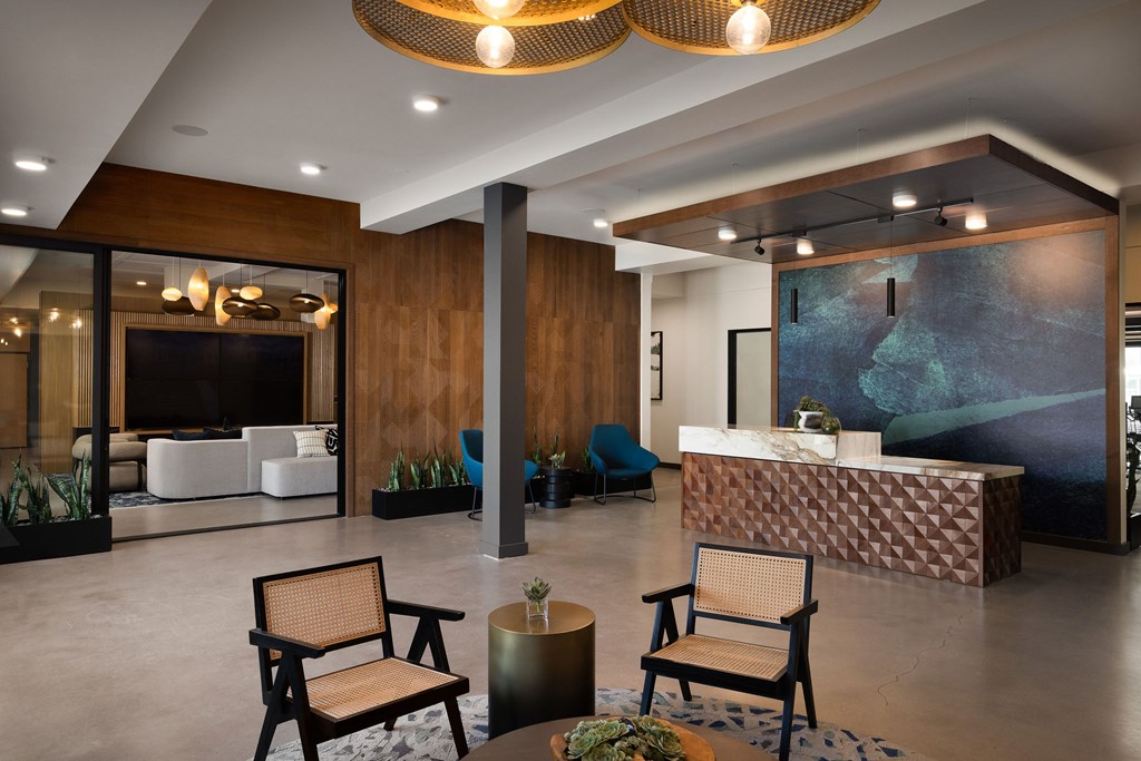 A reception area with a brown chair and a brown table.