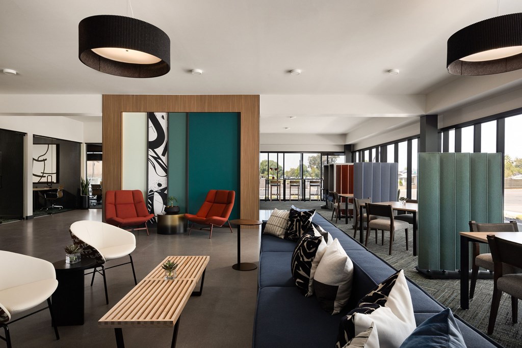 A modern living room with a blue couch and a wooden table.