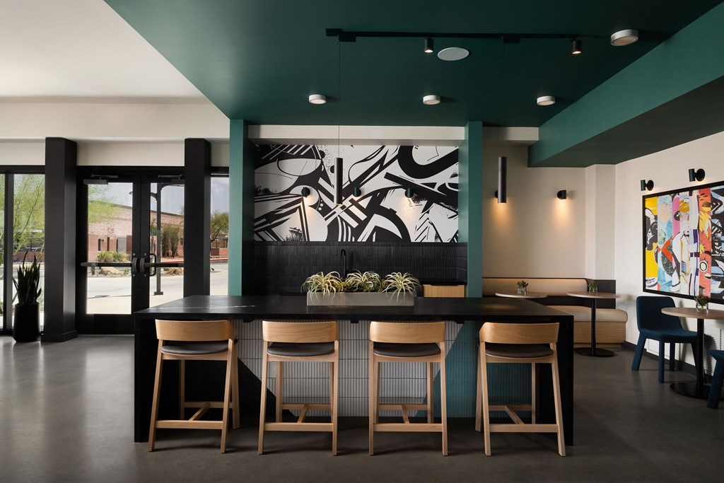 A modern dining room with a black and white mural on the wall.