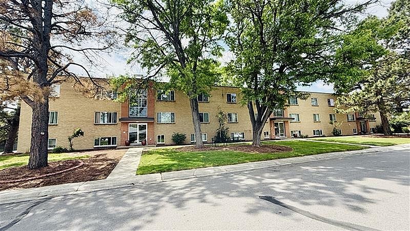 A large building with a tree in front of it.