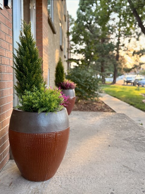 A brick building with a green pole in front of it.