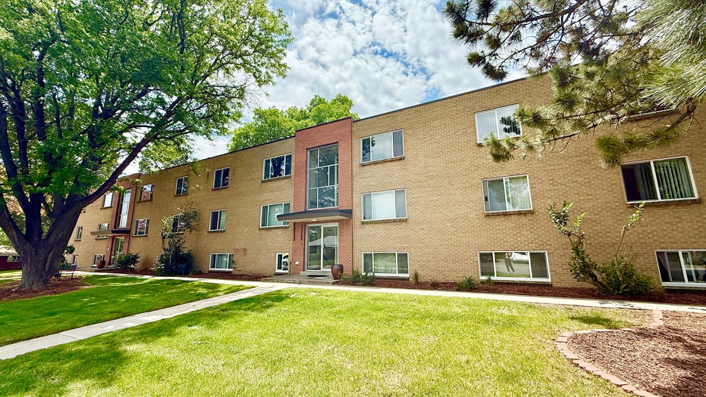 A building with a green lawn in front of it.