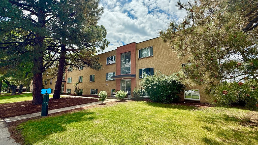 A building with a green sign in front of it.