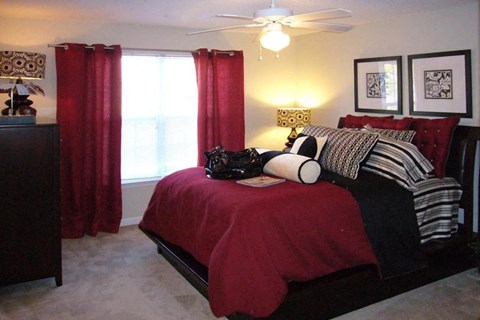 bedroom with a red bedspread at Palmera, South Carolina, 29229